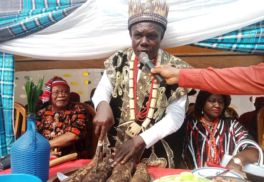 Eze Okeke cutting the yam for his people of Ihioma,during festival,held,recently.